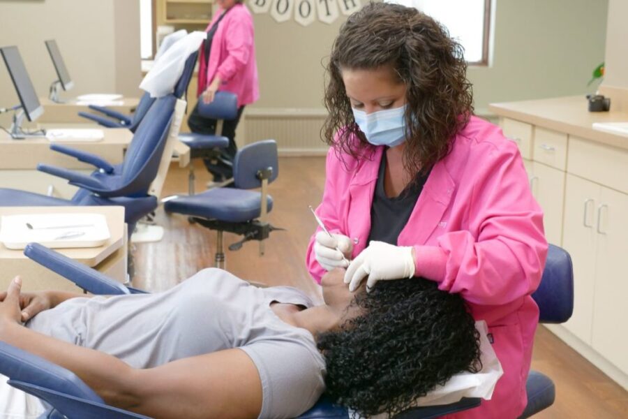 Langford assistant working on a patient's teeth